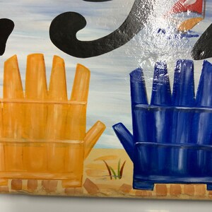 May include: Two painted wooden chairs, one yellow and one blue, are on a beach scene. The chairs are facing away from the viewer.
