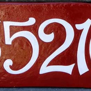 May include: A red house number plaque with white cursive numbers reading "35216".