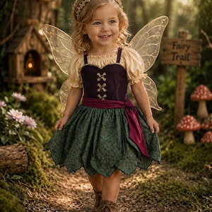 May include: A fairy costume featuring a dark purple bodice with gold lace-up detailing, cream-colored puff sleeves, and a dark green skirt with a leaf-like hem. The outfit includes a deep magenta waist sash, translucent gold wings, and a gold headband.
