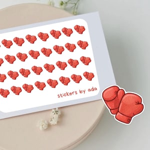 Może przedstawiać: Arkusz naklejek z czerwonymi rękawicami bokserskimi. Naklejki ułożone są w siatkę na białym tle. Tekst "stickers by ada" jest wydrukowany małą czcionką w prawym dolnym rogu.