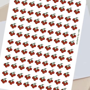 Pode incluir: Uma folha retangular de autocolantes branca com um padrão repetitivo de pequenas cerejas vermelhas com caules verdes. O texto "stickers by ada" está impresso verticalmente em letras pretas pequenas ao longo da margem direita.