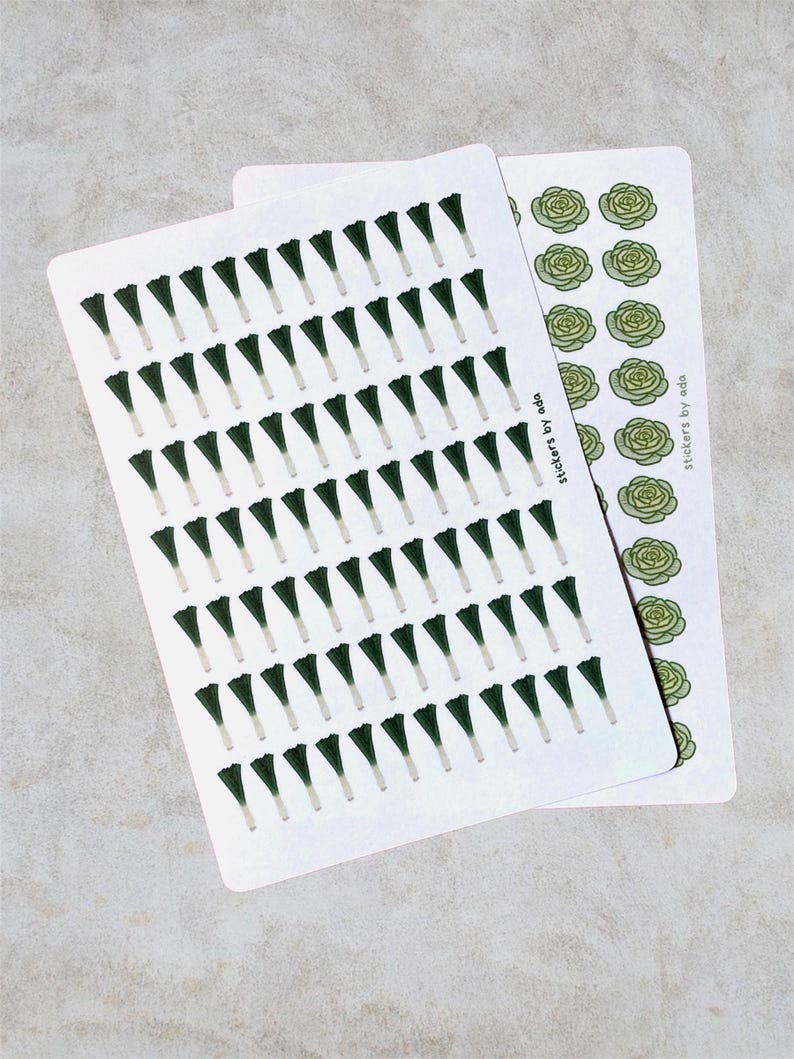 Example of how the sheets look like: Two sticker sheets with botanical designs. One sheet shows many dark green, leek illustrations with white stems. The second sheet features light green lettuce illustrations. The text "stickers by ada" is printed on the sheets.
