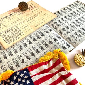 May include: Vintage ephemera featuring a War Ration Book No. 3, ration stamps, and a small American flag with red and white stripes and blue stars. Includes several vintage brass buttons.