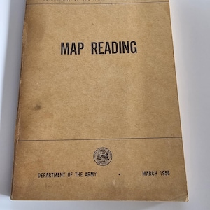 May include: A vintage manual titled "FM 21-26 MAP READING" from the Department of the Army, dated March 1956. The cover is a tan color with black text and a circular emblem.