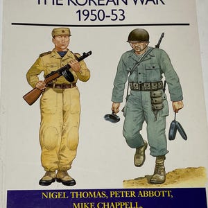 May include: Book cover from the "Men-at-Arms Series" titled "The Korean War 1950-53." The cover features illustrations of two soldiers in uniform, one in tan and the other in green. The book's authors are Nigel Thomas, Peter Abbott, and Mike Chappell.