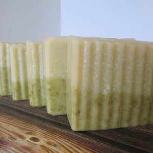 May include: Five bars of handmade soap with a light green and white layered design. The soap bars have a textured surface.