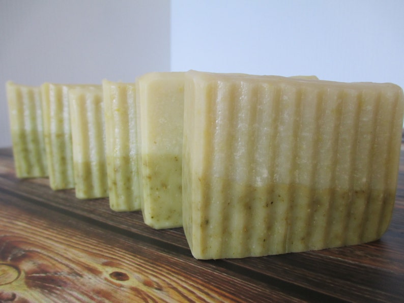 May include: Five bars of handmade soap with a light green and white layered design. The soap bars have a textured surface.