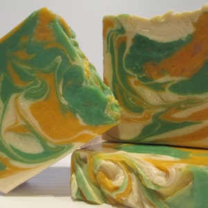 May include: Three bars of handmade soap with a swirl pattern of green, yellow, and white.