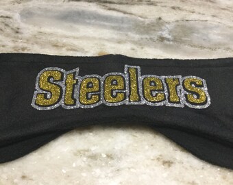 May include: Black headband with the word "Steelers" in gold glitter letters outlined in silver glitter.