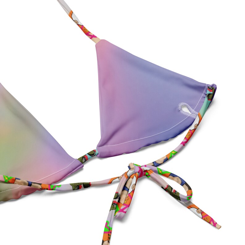 May include: A rainbow ombre bikini top with adjustable straps and a tie closure. The straps are printed with a colourful pattern.