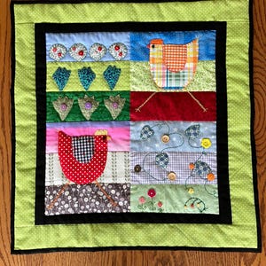 May include: A handmade patchwork quilt with a farm theme. The quilt features a green polka dot border, black inner border, and various fabric squares with appliqued chickens, flowers, and other farm-related designs. The quilt is square and appears to be machine-stitched.