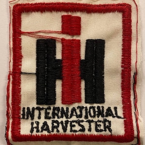 May include: Red and black embroidered patch with the International Harvester logo and text.