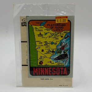 May include: A vintage Minnesota souvenir map in a plastic sleeve. The map features a green and yellow illustrated map of Minnesota with the text "Playground of 10,000 Lakes" and the word "Minnesota" in red. The sale price is $1.00.