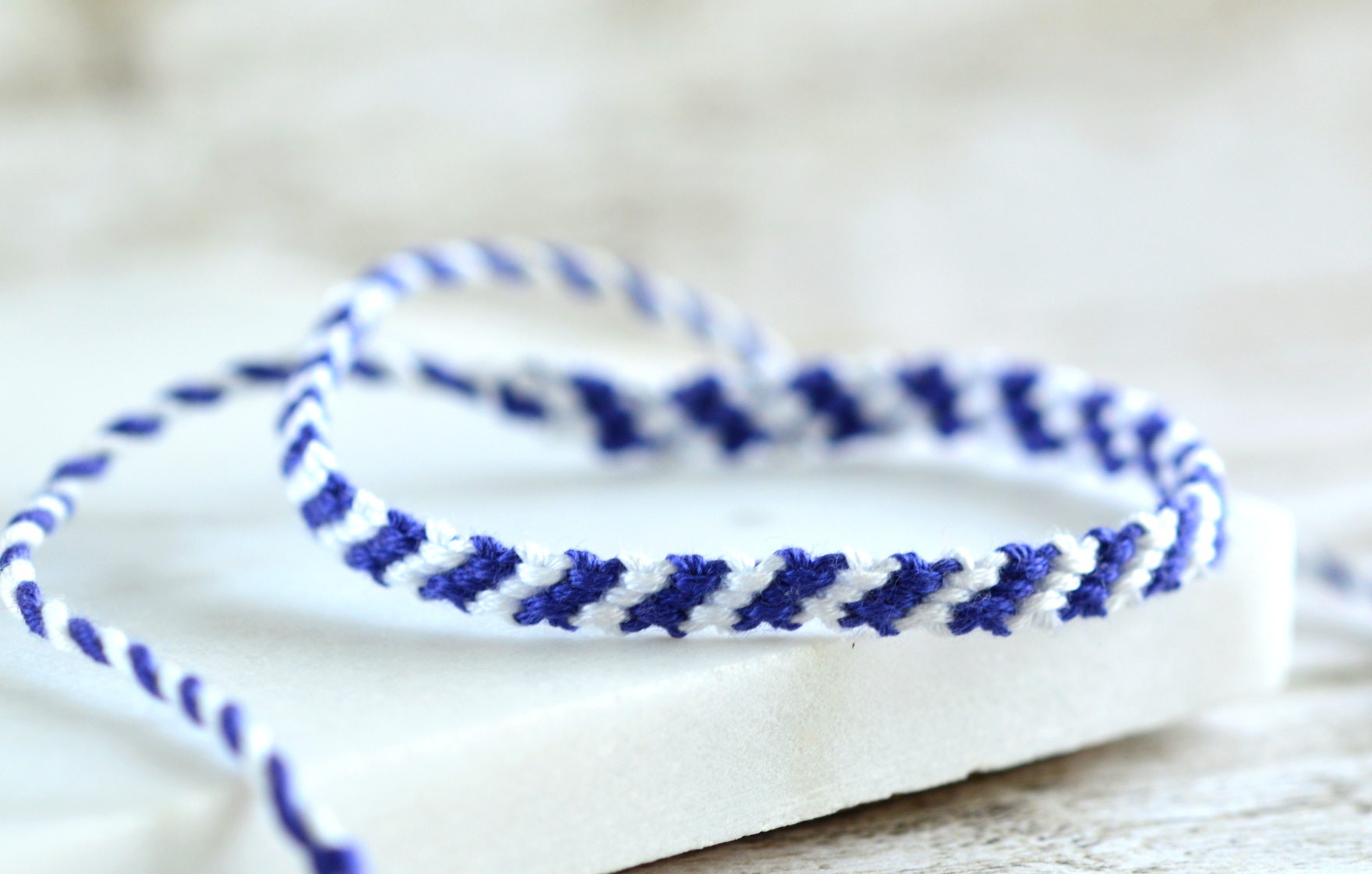 Premium Photo  Bracelets made of bisser blue white and gold beads for  bracelets weaving bracelets on the arm