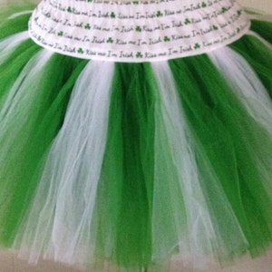 May include: Green and white tulle tutu skirt with a white elastic waistband that has the text "Kiss me I'm Irish" repeated around it.