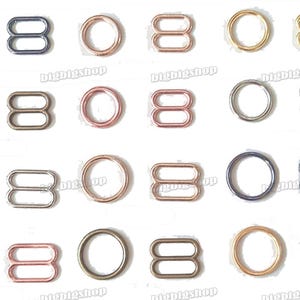 Puede incluir: Surtido de deslizadores de tirantes de sujetador de metal en varios tamaños y acabados, incluyendo oro, plata y oro rosa.