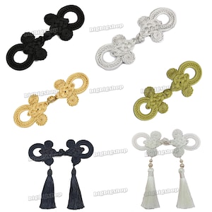 May include: Six pairs of decorative Chinese knot toggles in various colors, including black, silver, gold, green, and white. Some toggles have tassels.