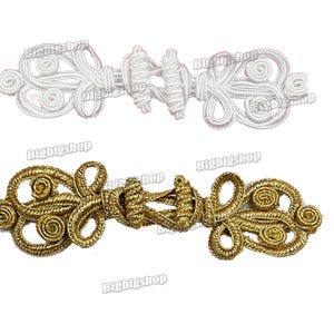 May include: Two decorative frog closures. One is white, the other is gold. The closures are made of twisted cord and feature a looped design. The text "Bigbigshop" is visible on the image.