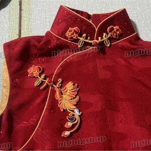 May include: A sleeveless, red garment with gold trim and intricate embroidery. The embroidery features a phoenix and floral designs in gold, orange, and red. The garment has a mandarin collar and is likely part of a traditional outfit.