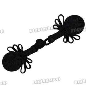 May include: Black fabric toggle clasp with two round button-like ends. The clasp is made of braided rope and has a decorative knot in the center.