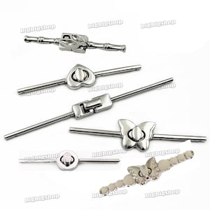 May include: A collection of silver-toned metal clasps in various designs. The clasps include a bamboo-style clasp, a heart-shaped clasp, a rectangular clasp, a butterfly-shaped clasp, a round clasp, and a bracelet clasp with a butterfly design.