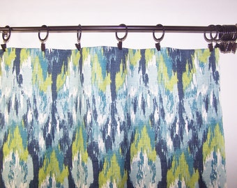 May include: Blue, green, and white patterned curtains hanging on a black curtain rod.