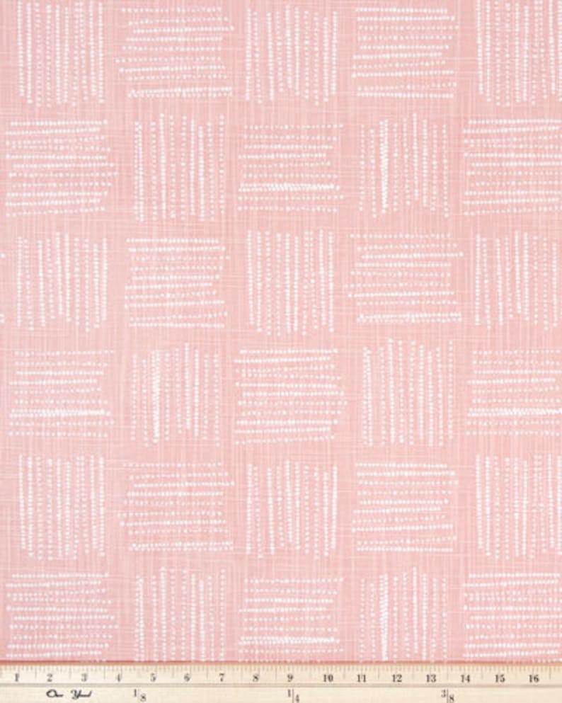 May include: Pink fabric with a repeating pattern of white dotted lines arranged in a grid. The lines are vertical and horizontal, creating a textured, geometric design. The fabric has a subtle, woven appearance.