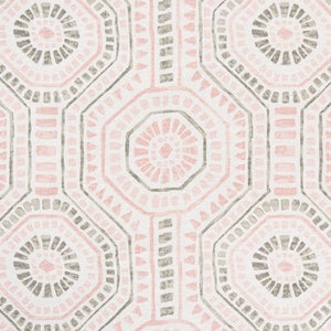 May include: Geometric patterned fabric in a repeating design. The pattern features octagonal shapes in shades of pink and gray, outlined with a darker gray on a white background. The fabric is likely used for home decor or apparel.