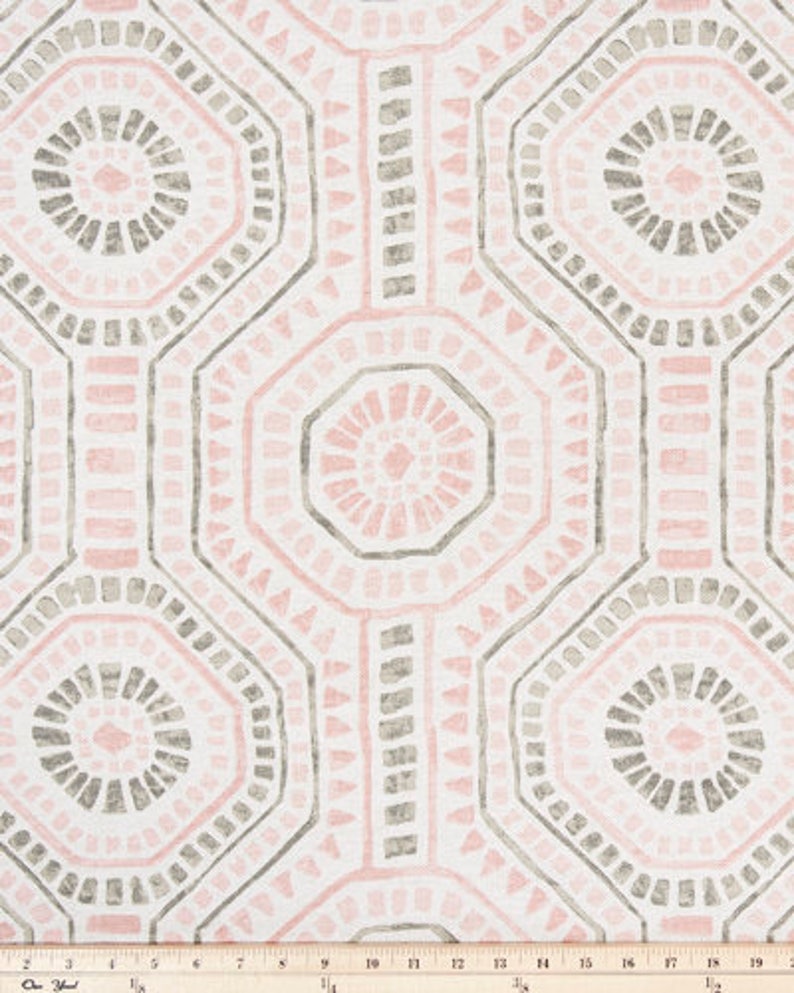 May include: Geometric patterned fabric in a repeating design. The pattern features octagonal shapes in shades of pink and gray, outlined with a darker gray on a white background. The fabric is likely used for home decor or apparel.