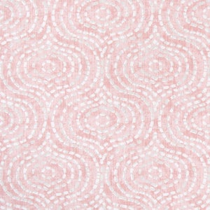 May include: Pink fabric with a repeating pattern of white, dotted, oval shapes. The fabric has a textured appearance and a ruler is at the bottom, measuring in inches. The design is reminiscent of an abstract, organic motif.