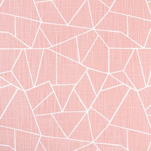 May include: A close-up of a fabric with a geometric pattern. The fabric has a light pink background with a white, linear design of irregular shapes. The fabric is textured and appears to be cotton or linen. The pattern is consistent across the fabric.