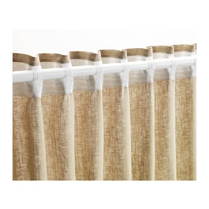 May include: Set of beige linen curtains with a white trim and a white rod. The curtains are hung in a window.