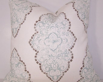 May include: A white throw pillow with a blue and brown damask pattern. The pillow is square and has a soft, plush feel.