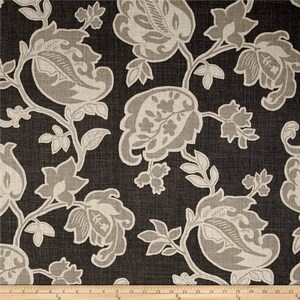 May include: A black fabric with a repeating pattern of beige floral designs. The fabric has a subtle textured appearance.