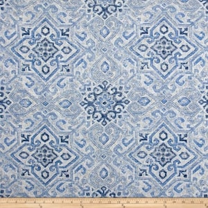 May include: Blue and white patterned fabric with a repeating geometric design. The fabric has a subtle texture and a soft, faded look.