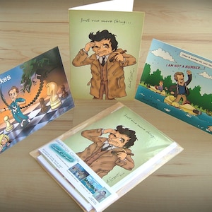 May include: Four greeting cards with humorous illustrations and text. The cards feature a chessboard, a man in a trench coat, a man on a jet ski, and a man in a trench coat with a cigar. The text on the cards reads "Queen takes Bishop", "Just one more thing...", "I AM NOT A NUMBER...", and "Just one more thing..."