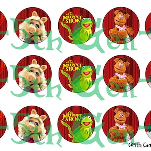 Może przedstawiać: Dziewięć okrągłych ozdób na babeczki z postaciami z Muppet Show. Ozdoby przedstawiają Miss Piggy, Kermit the Frog, Fozzie Bear, Animal i Sam Eagle. Ozdoby znajdują się na białym tle.