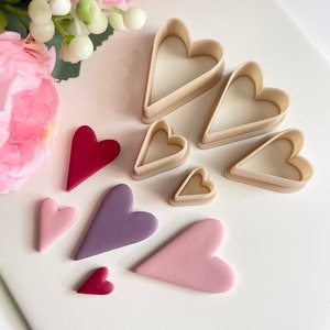 May include: Set of six heart-shaped cookie cutters in various sizes, with five heart-shaped pieces of fondant in different colors, including pink, purple, and red.