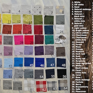 May include: A chart of 64 fabric swatches in various colors and patterns. The swatches are numbered 1 through 64. Each swatch is labeled with a color name, such as "White", "Off White", "Sand", "Natural Melange", "Natural", "Natural/Black Dots", "Natural/White Dots", "Natural/Gold Dots", "Light Yellow", "Bright Yellow", "Citrus Yellow", "Chartreuse", "Chartreuse/White Dots", "Emerald", "Forest", "Moss", "Orange", "Mustard", "Dark Rust", "Rust", "Rusty Red", "Burgundy", "Deep Sea Green", "White/Black Stripes", "Coral/White Dots", "Coral", "Rose/Black Melange", "Fuchsia", "Berry", "Boysenberry", "Jade", "Pinecones", "Baby Pink", "Dusty Pink", "Dusty Purple", "Lavender", "Violet", "Royal Purple", "Plum", "Cool Brown", "Dove Grey", "Dusty Blue", "Baby Blue", "Turquoise", "Classic Blue", "Royal Blue", "Steel Blue", "Dark Blue", "Greyish Blue/White Dots", "Greyish Blue", "Blue Melange", "Black Melange", "Gray", "Graphite", "Charcoal", "Black", "Tiny Blue/Beige Stripes", "Blue/Beige Stripes", "Tiny Black/Beige Stripes", "Black/Beige Stripes", "White Beige Checks", "Red Beige Checks", "Gray Beige Checks", "Blue Gray Beige Checks".
