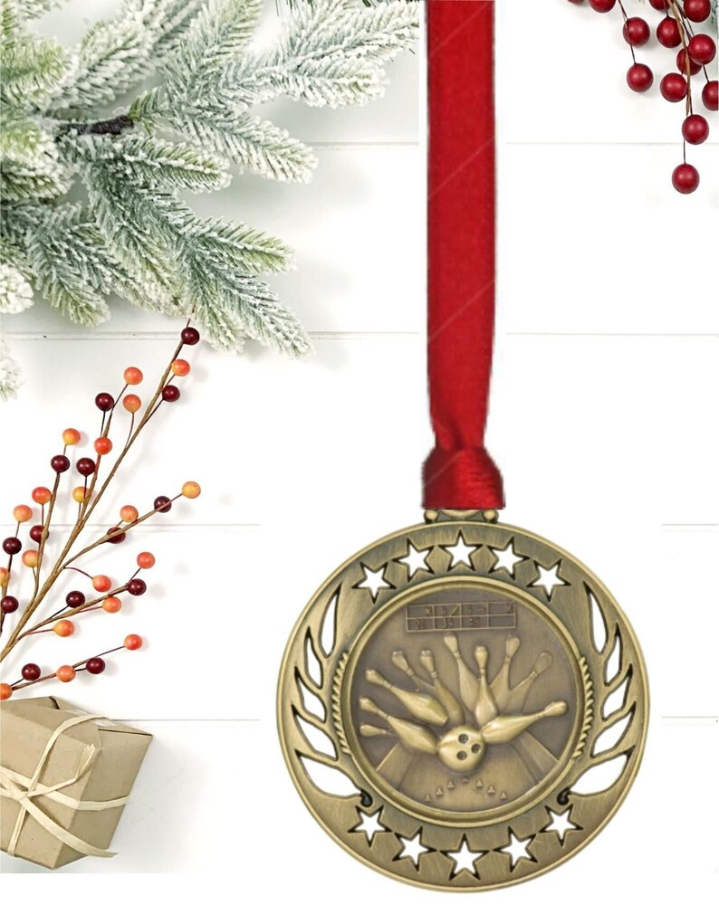 gold round bowling ornament with red ribbon and engraved plate on back