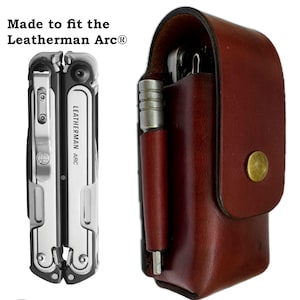 May include: A brown leather sheath with a brass button closure, designed to fit a Leatherman Arc multi-tool. The multi-tool is silver and black. Text on the image reads "Made in the USA".