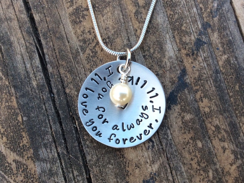 May include: Silver necklace with a round pendant that reads "I love you for always. I got you 11, 11, 11". A small pearl charm hangs from the pendant.