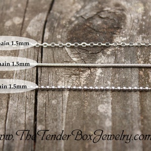 May include: Three silver chains on a wooden surface. The chains are labeled "Cable Chain 1.5mm", "Snake Chain 1.5mm", and "Ball Chain 1.5mm".