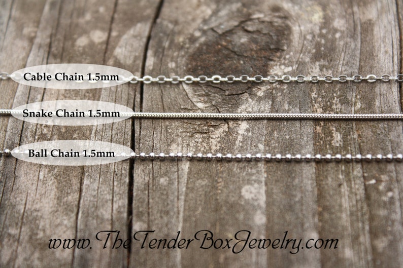 May include: Three silver chains on a wooden surface. The chains are labeled "Cable Chain 1.5mm", "Snake Chain 1.5mm", and "Ball Chain 1.5mm".