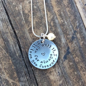 May include: Silver necklace with a round pendant that reads "I love you forever and always. I" with a small heart in the center. The necklace has a small pearl charm.