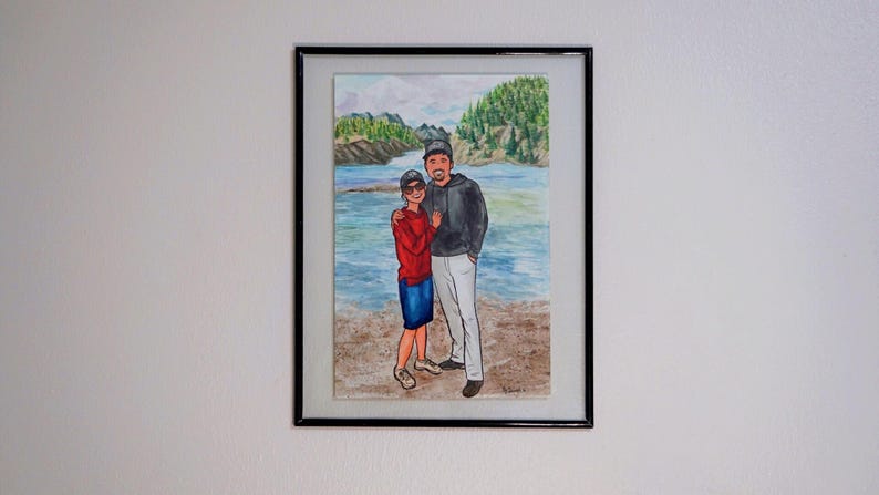 May include: A watercolor painting of a couple standing on a beach. The man is wearing a black jacket and a baseball cap. The woman is wearing a red shirt and blue jeans. The background is a watercolor painting of a lake and trees.