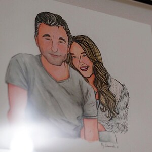 May include: A framed illustration of a couple. The man is wearing a gray shirt and the woman is wearing a white fur coat. They are both smiling.