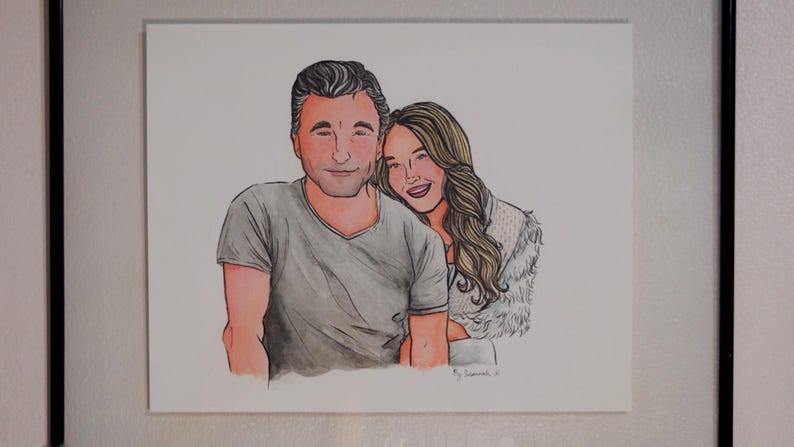 May include: A watercolor painting of a couple. The man is wearing a gray t-shirt and the woman is wearing a white fur coat. The painting is signed "By Laurencia"