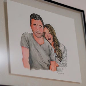 May include: A framed illustration of a couple, a man and a woman, smiling and looking at each other. The man is wearing a gray shirt and the woman is wearing a white shirt with a fur collar.