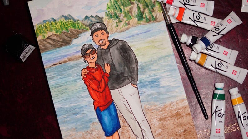 May include: Watercolor painting of a couple standing in front of a river and mountains. The woman is wearing a red sweater and blue skirt, and the man is wearing a black hoodie and white pants.